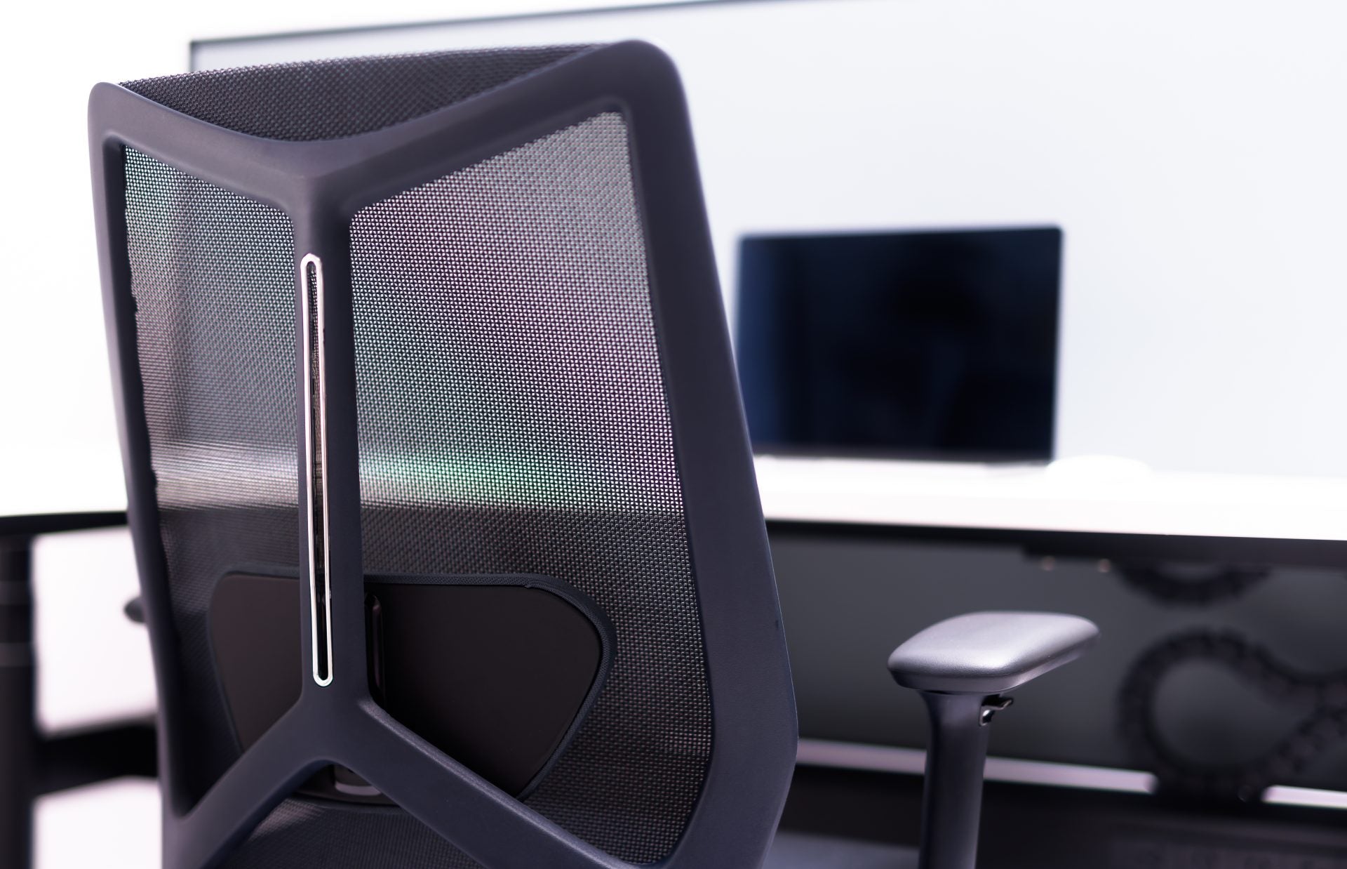 ARCO Chair shown at an office desk in a commercial workspace